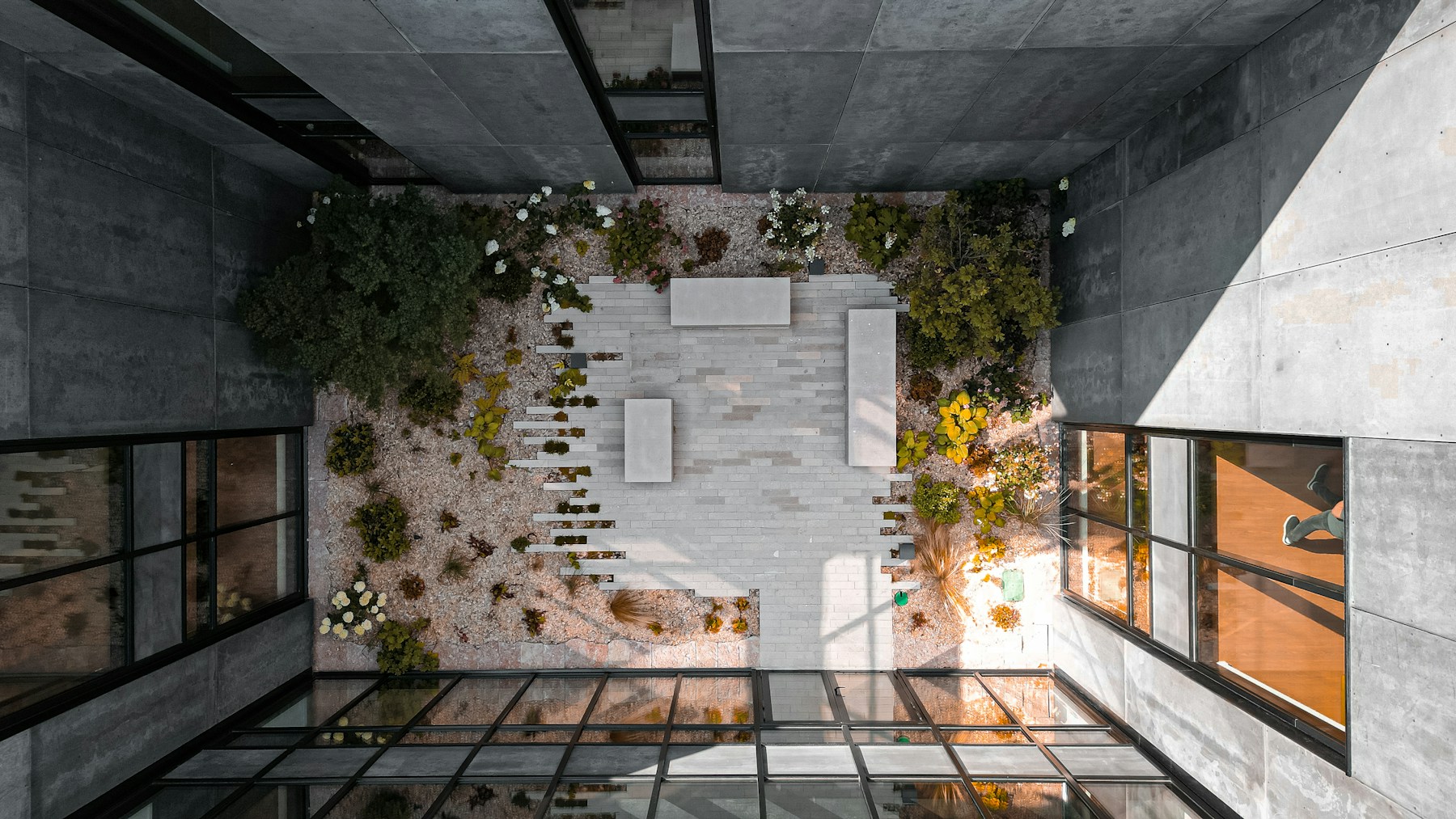 Concrete architecture framing a peaceful green courtyard